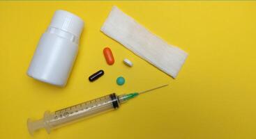 injectable pill medication on a yellow background photo