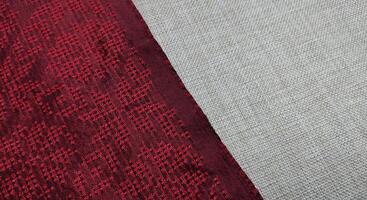 Texture, background, pattern. The fabric is red with a pattern of geometric figures. This is a detailed close-up of the fabric. photo