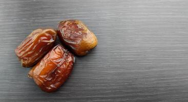 Dried dates on a black background, close-up, selective focus photo