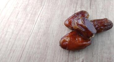 Dates fruit on wooden table. Top view with copy space. photo