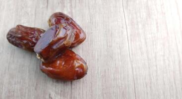 Dates fruit on wooden table. Top view with copy space. photo