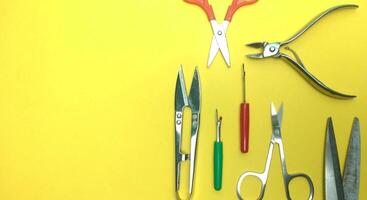 various sewing equipment seen from above on a yellow background photo