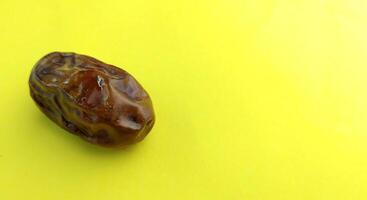 Dates fruit on a yellow background with copy space for text. photo