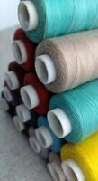 Rolls of multi-colored threads for tailors working in the garment embroidery sector photo