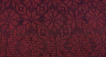 Texture, background, pattern. The fabric is red with a pattern of geometric figures. This is a detailed close-up of the fabric. photo