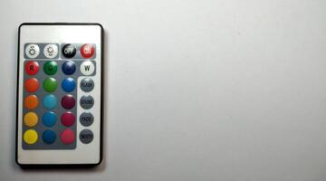 TV remote control with multicolored buttons isolated on white background. photo