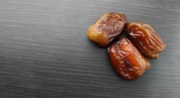 Dried dates on a black background, close-up, selective focus photo