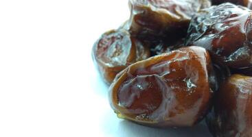 Dates fruit isolated on white background. Close up. Selective focus. photo