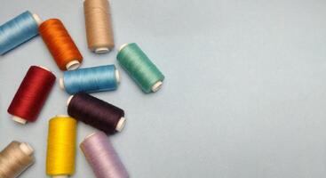 spools of thread on a blue background. place for text. photo