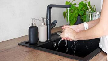 Woman washes hands and uses soap from reusable bottle. Eco-friendly lifestyle. High quality 4k footage video