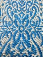 Blue and white woven mat with motif designs on it photo