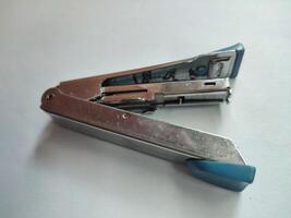 Iron-based blue stapler isolated on white background photo