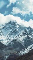 AI generated Snowy mountain with clouds in a blue sky, a natural landscape photo