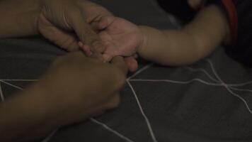 Children's hand in the palm of his father. Son holds father's hand. video