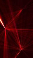Vertical video - high speed laser light show on black background with flashing red colored laser beams. This music performance nightlife background animation is full HD and a seamless loop.