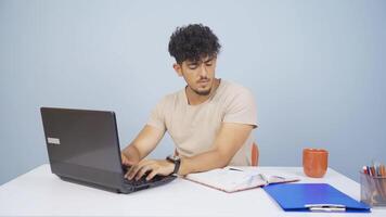 Man working on laptop throws files angrily. video