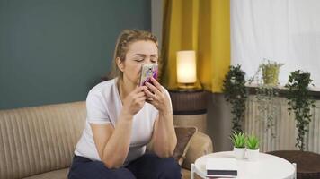 Longingly, the woman looks at the photo on the phone. video