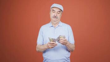 Man counting money looking at camera. video