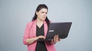 An angry business woman angrily closes her laptop. video