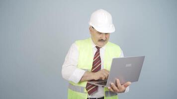 Engineer holding laptop laughing at camera. video