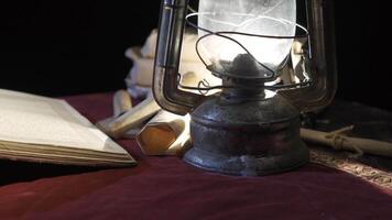 Worn history book of ancient times. Reading by kerosene lamp. video