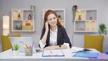 Home office worker woman scratches her ears looking at camera. video