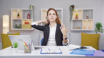 Home office worker woman looks at camera with happy and smiling face. video