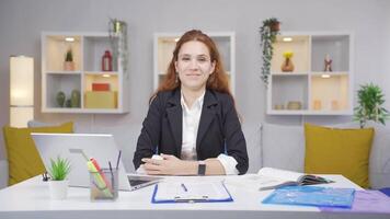 Home office worker woman looking smugly at camera. video