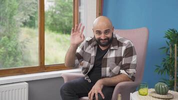 Happy man waving at camera. video