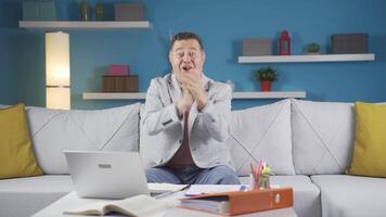 Home office worker man looking at camera clapping and getting excited. video