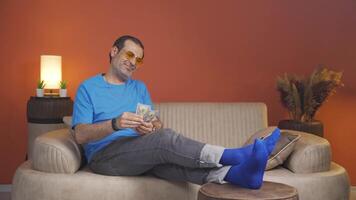 Man counting money looking at camera. video