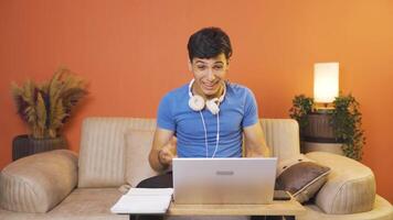 Man looks at laptop and rejoices. video