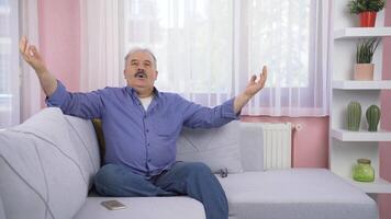 Happy old man looks out the window and takes a deep breath. video