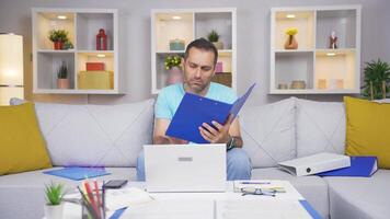 Home office worker man looking at the file angrily. video