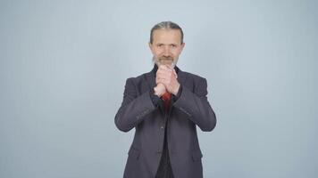 Businessman making a trust sign at the camera. video