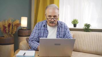 Man looking at laptop in amazement. video