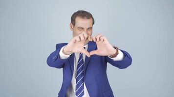 Businessman making heart at camera. video