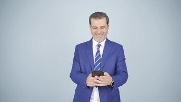 Businessman texting on the phone. Happy emoticon. video