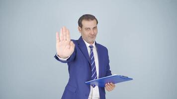 Businessman saying stop to camera. video