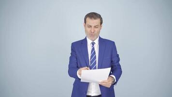 Businessman looks at the document in his hand and rejoices. video