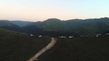 People on famous Bakhmaro sunset viewpoint watch sunset over clouds in Georgia video