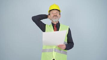 Looking up, the engineer is holding his hard hat. video