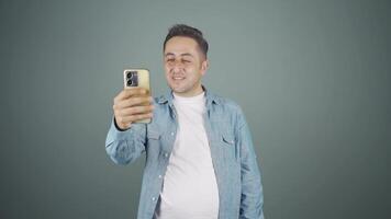 Man making a video call on the phone.