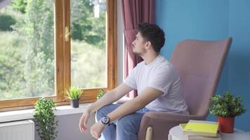 Christian man praying in front of the window. video