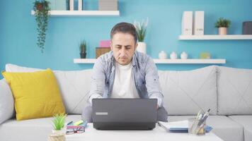 Negative expression of man using laptop. video