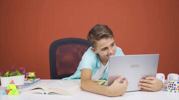 Boy joyfully embracing laptop. video