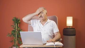 Man working on laptop has a headache. video