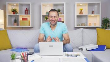 Home office worker man looking at camera with excitement and feeling happy. video