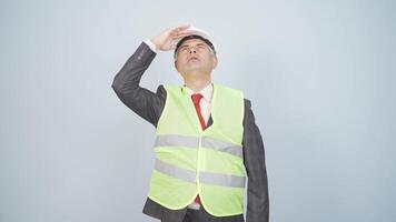 Looking up, the engineer is holding his hard hat. video