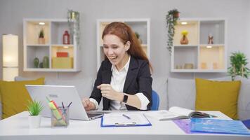 Home office worker woman reading good news and feeling happy. video